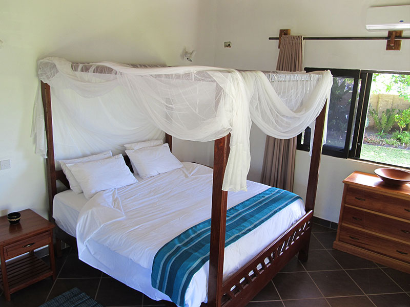 Comfortable bedroom with air conditioning and fan