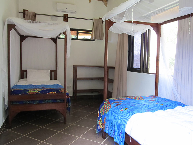 Twin bedroom with mosquito nets